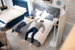 Pareja sobre una cama King Size en una tienda
